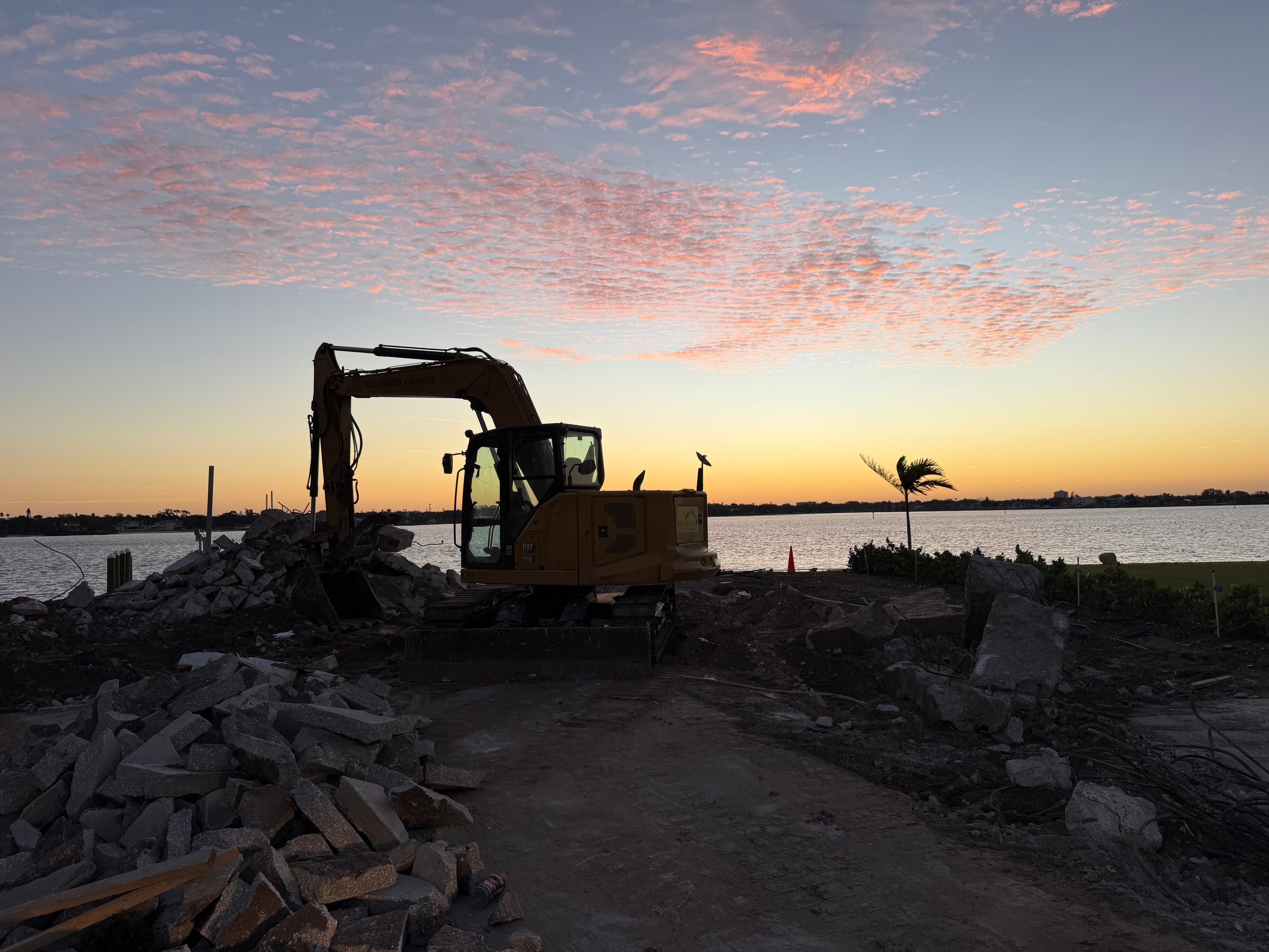 Waterfront home demolition at sunset in St. Petersburg, Florida