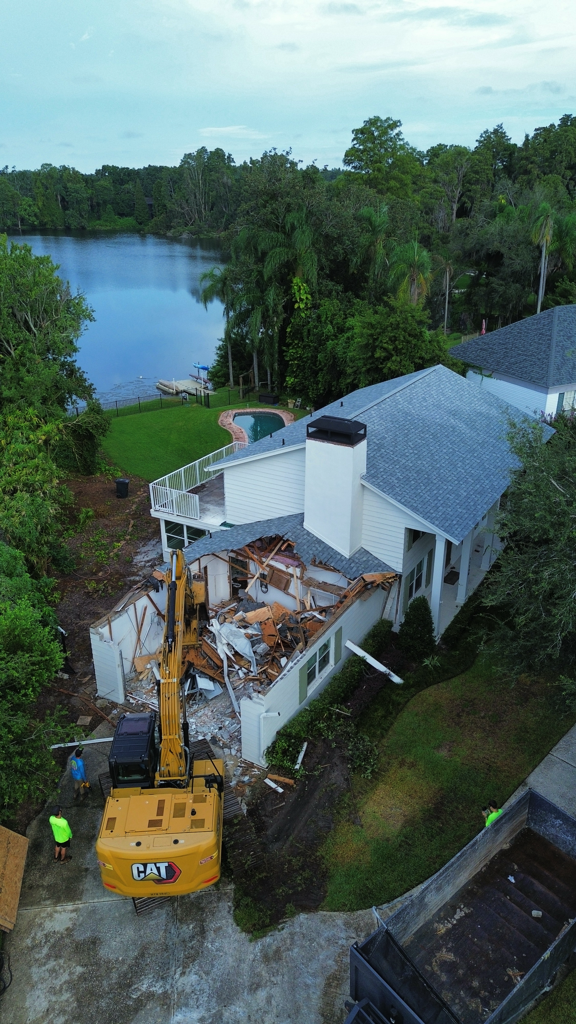 Mojo excavator working on a waterfront Tampa Bay demolition project